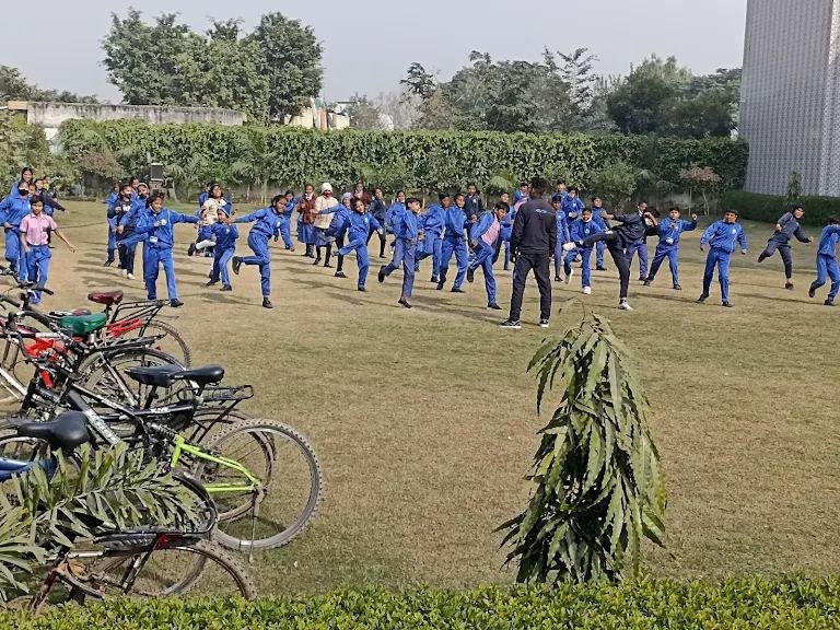 Students in PT uniform doing group exercise on the school lawn