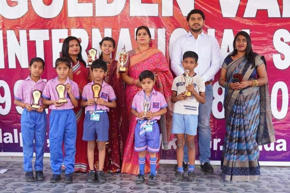 Students receiving trophies at a school award ceremony