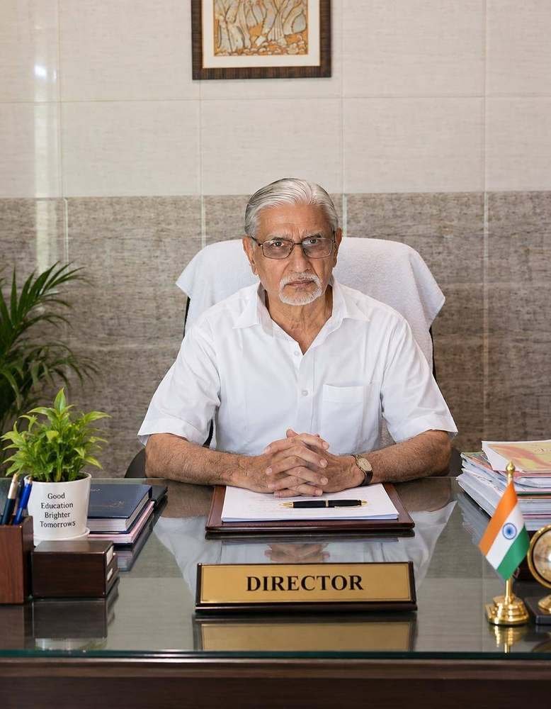 School Director at his office desk