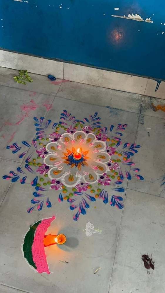 Students making a rangoli design for Diwali