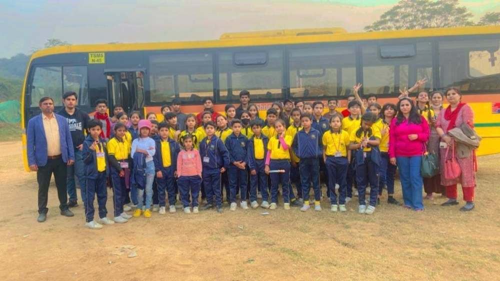 Students and staff with the school bus during an excursion